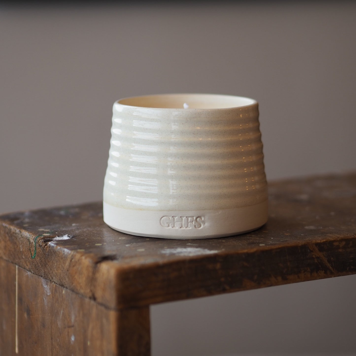 Hearth and Home refillable candle on stool