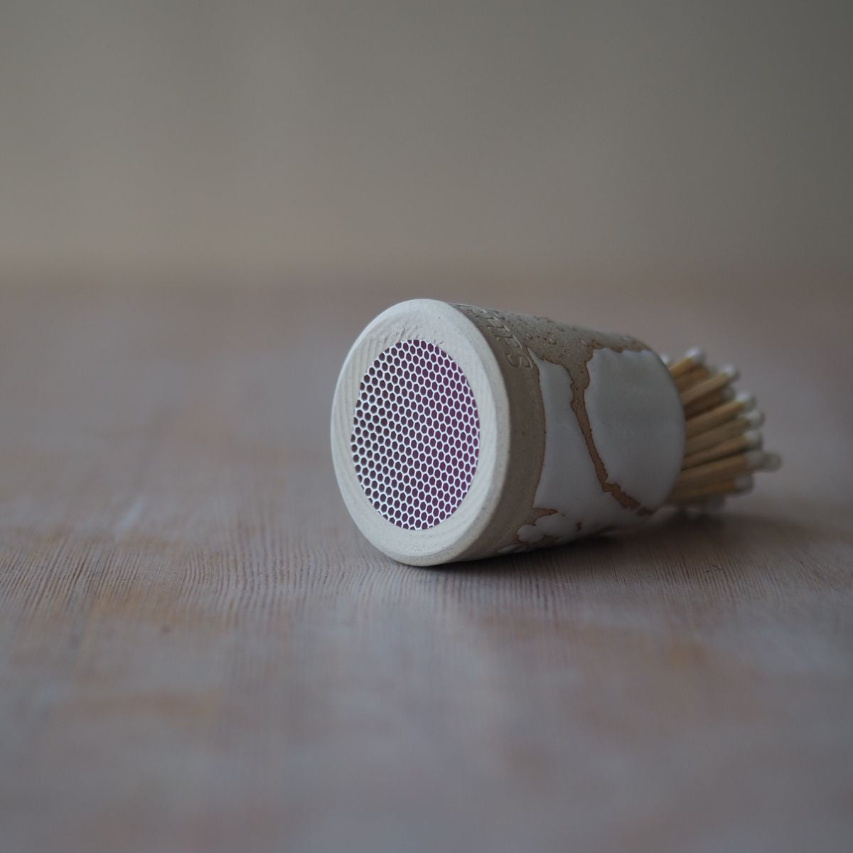 Strike pad on match pot